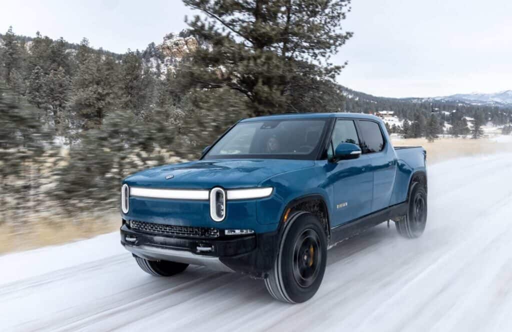 Rivian R1T driving through snow