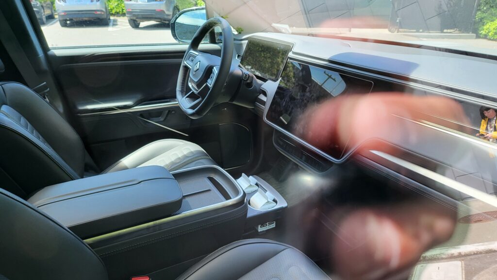 About the best look at the new R1S interior with sports a new wireless charging pad and push-button release for the doors replacing the old classic door handle release